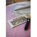 A cutting mat with a rotary cutter and a quilt-themed pouch labeled Quilt Time.