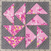 Quilt block with pink floral triangles on a gray patterned background, arranged in a geometric design.