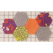 Colorful hexagonal fabric patches in various patterns arranged on a grid background.