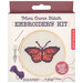 Packaging for a mini cross stitch embroidery kit featuring a butterfly design, includes needle and yarn.