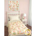 A cozy bedroom features a bed with the Patchwork Panel quilt and the wall hanging, all in pastel colors.