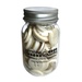 A plastic jar filled with assorted buttons in white, labeled Buttons Galore.