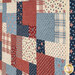 An angled close up of the patchwork featuring red, white, and blue patterns, including stars and stripes.