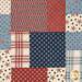 A head-on close up of the patchwork featuring red, white, and blue patterns, including stars and stripes. Top quilting details can also be seen.