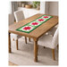 A wooden table with the December runner in Christmas colors, surrounded by white chairs.