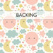 White swatch of fabric with a pattern of yellow crescent moons, pink full moons, and teal blue clouds as well as multicolored stars. A transparent banner at the top reads "Backing."