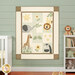 The completed On Safari quilt kit colored in solid fabric and laser cut appliqué, hung on a green paneled wall and surrounded by coordinating décor.