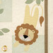 A close up shot of the laser cut appliqué lion jumping down from a tree. 