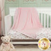 The completed Double Lush Satin Binding Blanket, artfully draped over a white crib with one side down, fitting with a coordinating floral sheet against a sage green background. A teddy bear sits in the foreground.