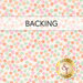 A swatch of white fabric with tossed small pink, coral, green, and orange flowers, a banner at the top reads "Backing" and a golden Shabby Fabrics logo rests in the corner. 