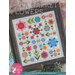 A framed quilt pattern titled Flea Market Flowers featuring colorful floral designs in a grid layout.