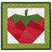 The completed June project depicting a strawberry in red, white, and green fabrics, isolated on a white background. 