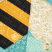 A super close up on the paper pieced bee, showing details on the fabrics including the gold glitter wings.
