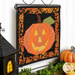 An angled shot of the October project, hung from a display hanger, staged with coordinating Halloween décor.