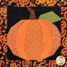 A close up on the pumpkin without the laser cut pieces, showing fabric color and print details.