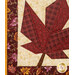 A super close up on the project, demonstrating fabric color and print details on the leaf, border, and binding.