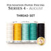 Five spools of white, yellow, teal blue, and black thread, isolated on a white background. 