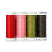 Four spools of red, pink, medium and dark green thread, isolated on a white background. 