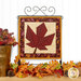 The completed Foundation Paper Piecing Series 4 November project, featuring a maple leaf in warm rust red, mahogany, and cream prints, displayed on a craft hanger and staged with coordinating foliage.