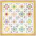 The completed vibrant patchwork Sunshine Day Quilt, colored in prints from the 30s Playtime collection by Moda Fabrics, isolated on a white background.