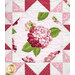 A head on close up of one of the fussy-cut hydrangea blocks, demonstrating details on the fabrics, pearlized accents, and top quilting.