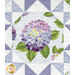 A head on close up of one of the fussy-cut hydrangea blocks, demonstrating details on the fabrics, pearlized accents, and top quilting.