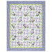 The completed Patchwork Quilt colored in periwinkle, lilac, green, and white fabrics from the Hydrangeas In The Garden collection from Riley Blake Designs, isolated on a white background.