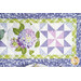 A top-down shot of the runner, demonstrating details on a fussy-cut hydrangea block as well as a pinwheel block.