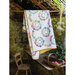 The completed Alice's Country Diary Quilt draped over a pole in a shed 