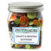 A glass jar filled with assorted buttons in halloween colors, labeled Buttons Galore.