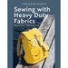 The front cover of the Sewing With Heavy Duty Fabrics Book showing a yellow backpack on a wooden dock on the water.