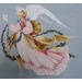 A delicate winged angel adorned in a flowing gown with ribbons and garland with a dove.