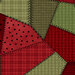 Red and green fabric in varying styles and shades with many different patterns of flannel and dots. 