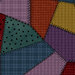 Dark multicolor fabric in varying styles and shades with many different patterns of flannel and dots. 