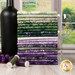 A stack of the fabrics included in the Wine Country collection, with a garden and a window and a wine bottle and a wine glass and grapes and thread.