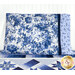 The completed Blue Belle pillowcase, colored in blue and white floral fabrics from the Blue Belle collection by Maywood Studio. The pillowcase is staged on a bed with the matching Keyboard Kaleidoscope Quilt.