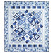 The completed Keyboard Kaleidoscope Quilt in blue and white floral fabrics from the Blue Belle collection by Maywood Studio, isolated on a white background. 