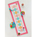 Colorful table runner with hexagonal patterns, surrounded by candy bowls and various sweets.