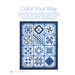 A quilt featuring various blue and white patterns arranged in a grid, showcasing intricate designs.
