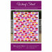 The front of the Wharf Street pattern with photo of finished quilt staged in front of a white fence.