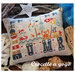 Embroidered pillow featuring a seaside theme with a lighthouse, crab, seashells, and the word SUMMER.