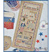 A festive patriotic display featuring a stitched art piece with phrases celebrating the 4th of July.