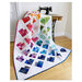 The completed Scrappy Love quilt finished and staged on an antique sewing machine. 