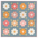 The completed Vintage Blooms Quilt, colored in blue, pink, peach, and soft white fabrics from the Wild Honey collection by Lella Boutique for Moda Fabrics, isolated on a white background.
