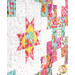 An angled super close up image of the quilt, showing the colors of the fabrics, patchwork design, and the top stitching effects.