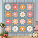 The completed Vintage Blooms Quilt, colored in blue, pink, peach, and soft white fabrics from the Wild Honey collection by Lella Boutique for Moda Fabrics, staged on a blue paneled wall and staged with coordinating flowers and décor. 