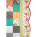 A super close up on the right side of the quilt, demonstrating details on the fabric colors and scalloped border.