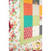 A super close up on the bottom left corner of the quilt, demonstrating details on the fabric colors and scalloped border.