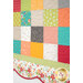 A super close up on the bottom of the quilt, demonstrating details on the fabric colors and scalloped border.