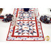 A close up image of half of the table runner, showing fabric color and details, surrounded by matching place settings.  